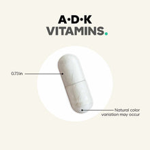 White capsule pill measuring 0.73 inches with natural color variation, labeled A•D•K Vitamins.
