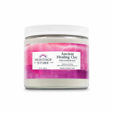 Pink and white clay mask in a clear glass jar with white ribbed lid, labeled Ancient Healing Clay by Heritage Store, 16 oz.