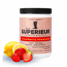White canister with black lid and pink label showing strawberry lemonade flavor, displayed with fresh lemons and strawberries