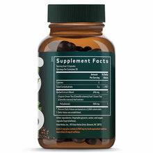 Amber glass bottle with green cap containing dark capsules and green tea supplement facts label.