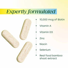 Three cream-colored capsules with red specks next to ingredient list including biotin, vitamins, minerals, and bamboo extract