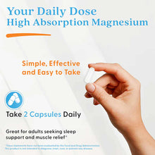 Hand holding white capsule with product packaging displaying magnesium supplement information and dosage instructions.