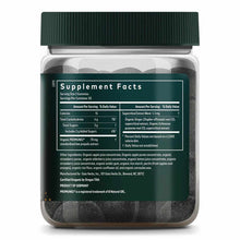 Bottle of dark round gummies with green cap and label displaying supplement facts and ingredients.