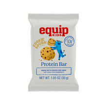 A gray Equip Kids cookie dough protein bar wrapper featuring a blue cartoon cow hugging a large chocolate chip cookie.