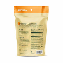 Tan pouch with orange header labeled "Om Mushroom" containing Lion's Mane mushroom powder supplement with usage and nutrition