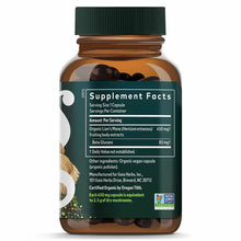 Amber glass bottle with green cap containing dark capsules and labeled with supplement facts for Lion's Mane Mushroom extract