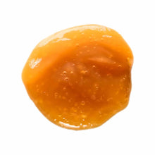 Orange gel packet with spherical shape and liquid interior, single supplement dose sachet.