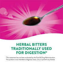 Metal spoon holding dark brown herbal bitters liquid against pink background with text describing traditional digestive use.