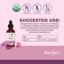 Dark red glass dropper bottle with black cap on pink background showing USDA organic, sugar-free, gluten-free, and nut-free c