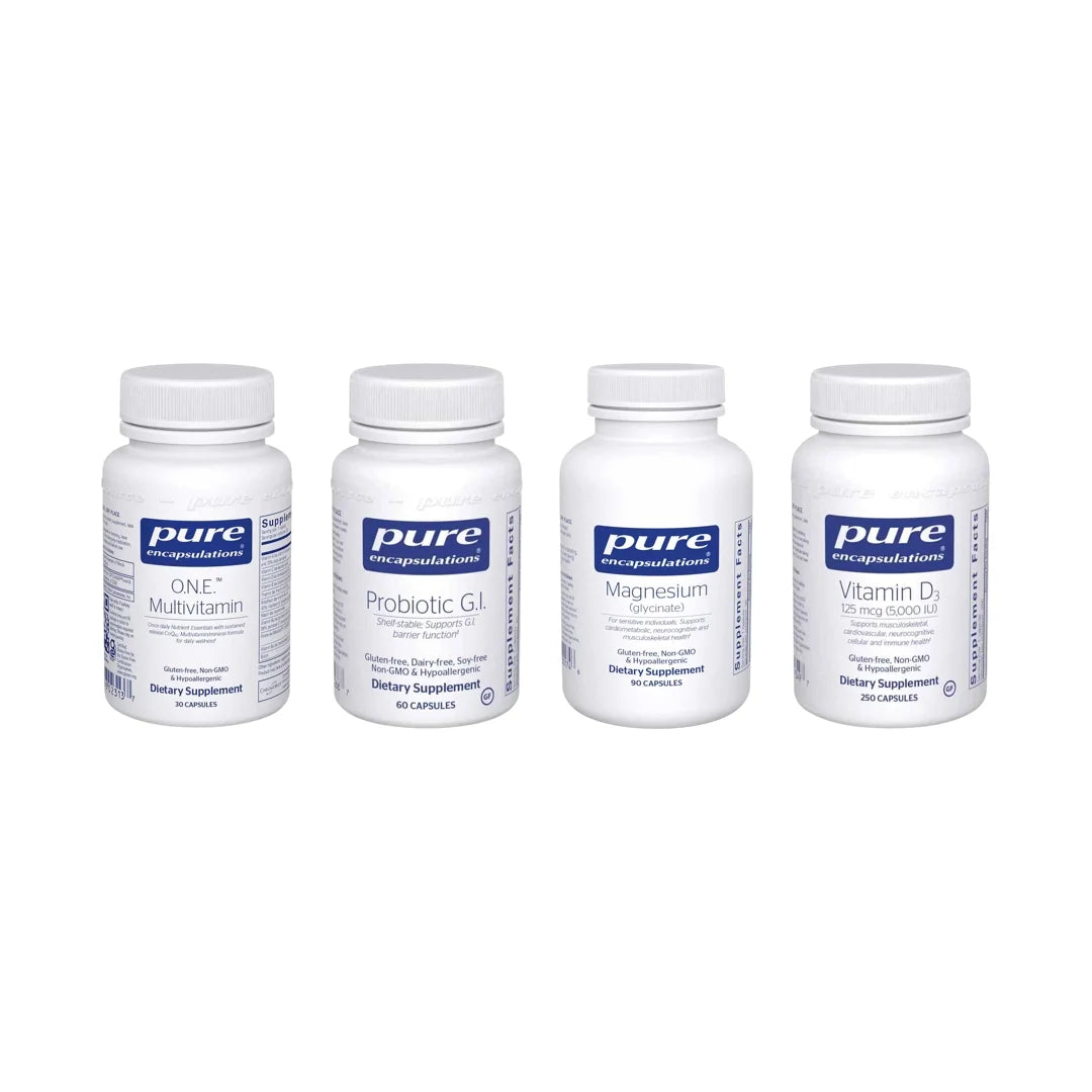 Four white supplement bottles with blue labels: ONE Multivitamin, Probiotic G.I., Magnesium, and Vitamin D3.