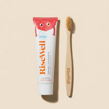 RiseWell kids toothpaste in Cake Batter flavor and wooden toothbrush with natural bristles.
