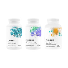 Three white supplement bottles labeled Basic B Complex, Basic Nutrients 2/Day, and Super EPA with colorful watercolor designs