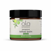 Brown glass jar with black cap containing bergamot tallow balm for hands by Ola Botanicals, 2 oz.