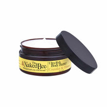 Naked Bee Ultra-Rich Body Butter in Coconut & Honey with dark glass jar and black lid, partially open.