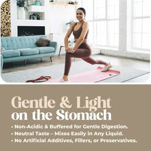 Woman performing a stretching exercise on a pink mat in a bright living room with a turquoise couch.