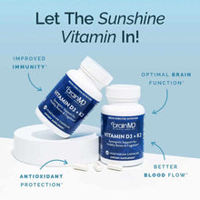 Two BrainMD Vitamin D3 + K2 supplement bottles with white capsules displayed on a white platform against a light blue backgro