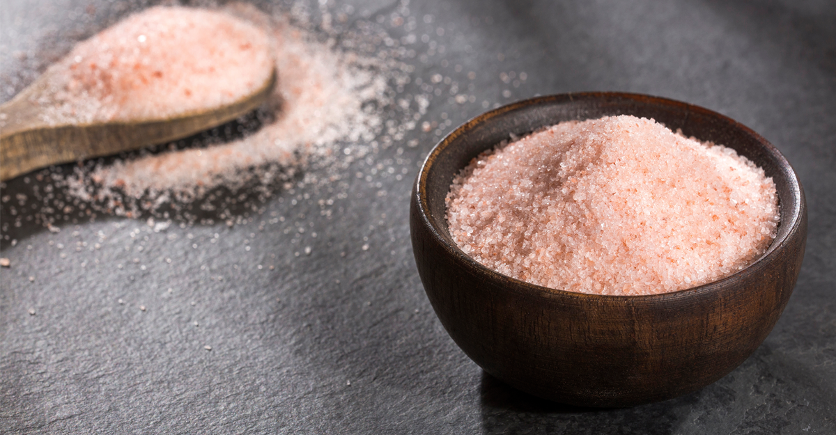  A bowl and wooden spoon full of Himalayan pink salt