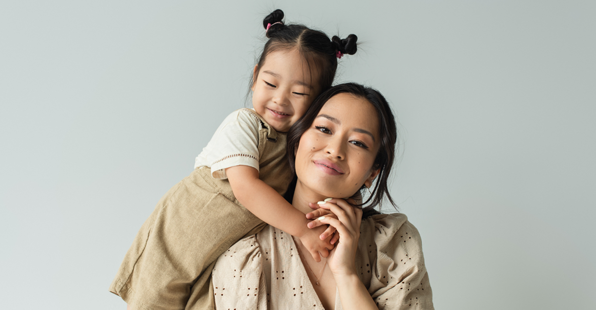 A young girl on her mothers back