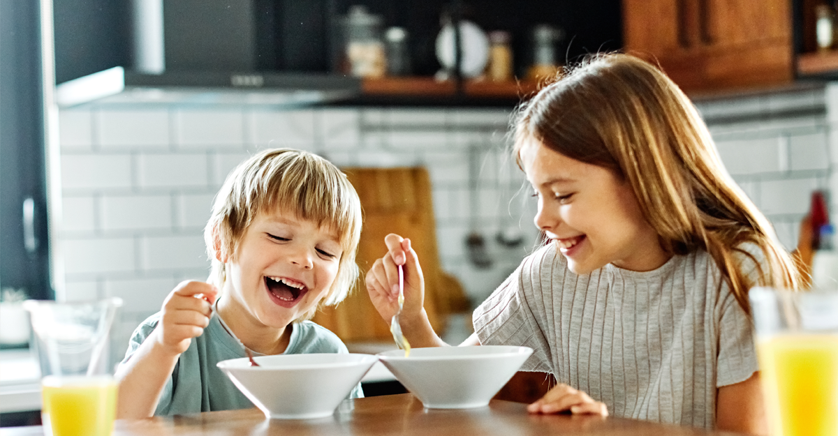 Two children enjoying breakfast