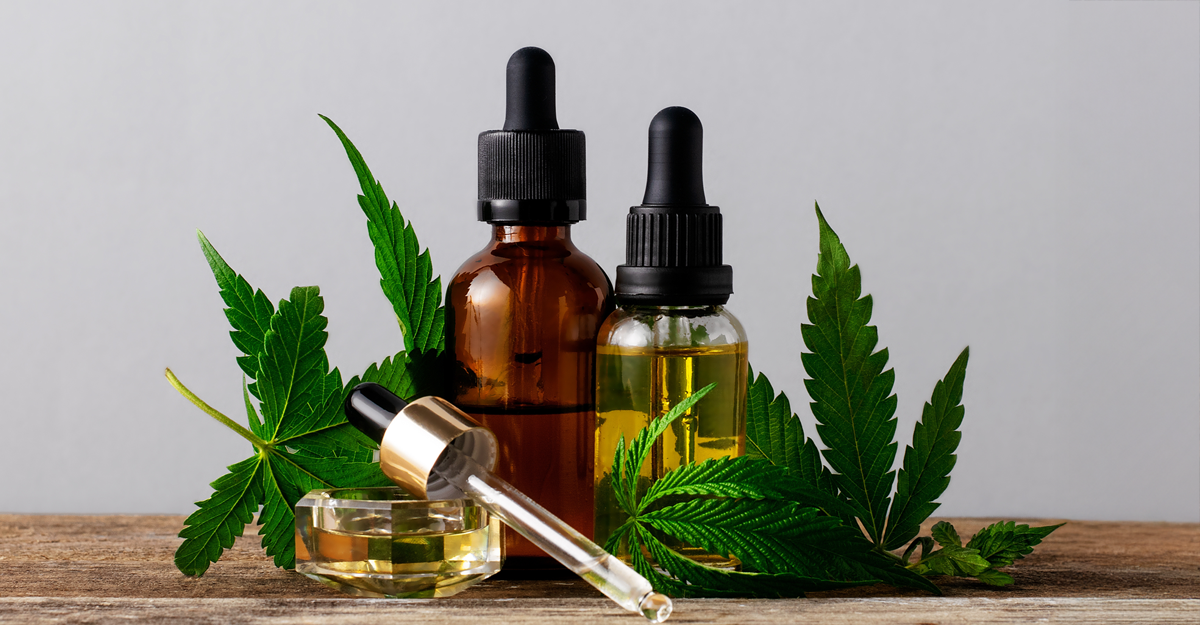 Glass tinctures with marijuana leaves surrounding them