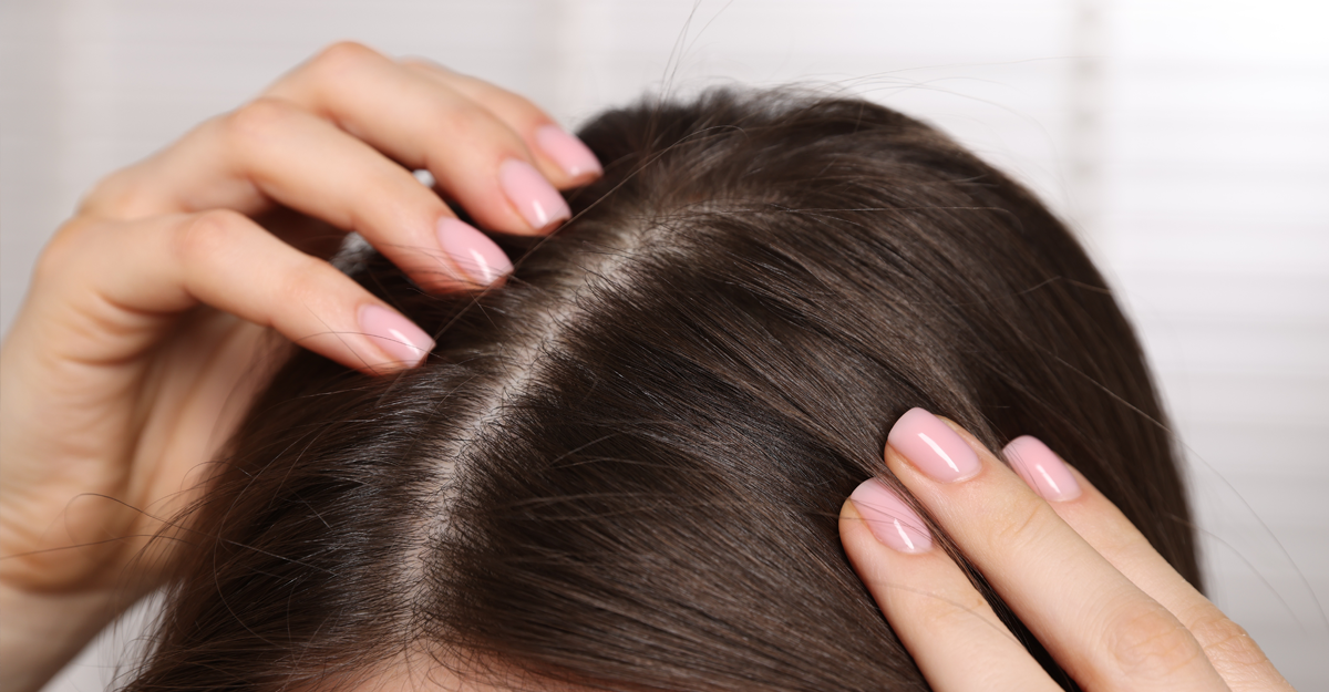 A womens dark hair overlooking her clean scalp