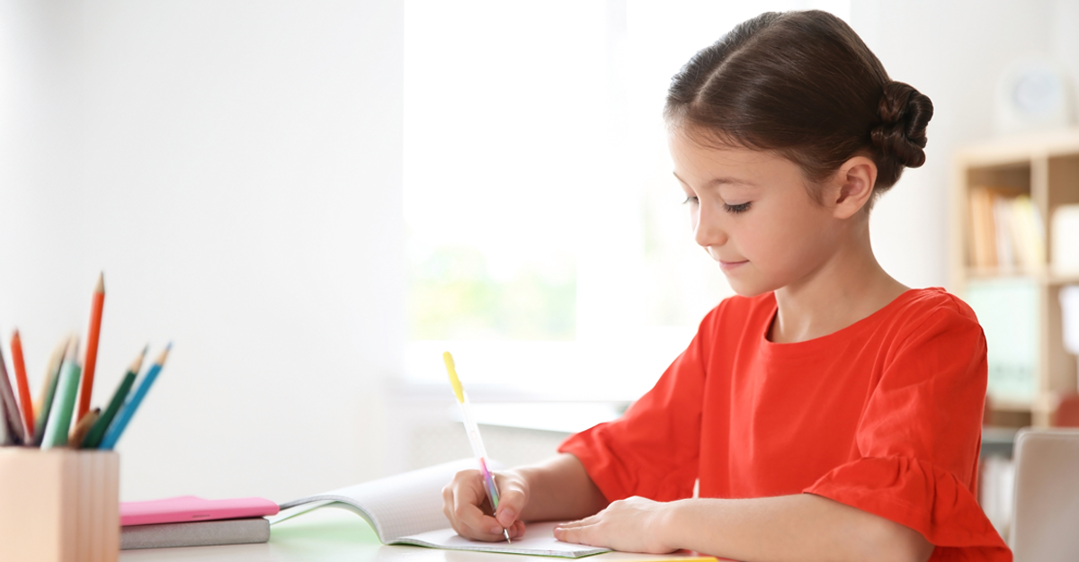 A girl writing on a table