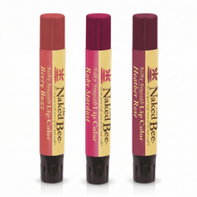 Three lip color tubes in shades of red, burgundy, and deep plum with gold and cream labels.