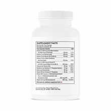 White plastic bottle of Basic Nutrients 2/Day capsules by Thorne Research with supplement facts label visible.