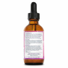 Amber glass bottle with black dropper cap and pink label containing castor oil and tea tree treatment.