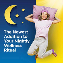Woman in white shirt and beige pants holding pink pillow against blue and yellow background with moon and stars.