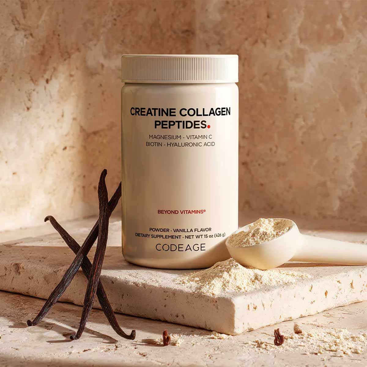 Codeage Creatine Collagen Peptides powder in vanilla flavor with vanilla beans and scoop on stone surface.