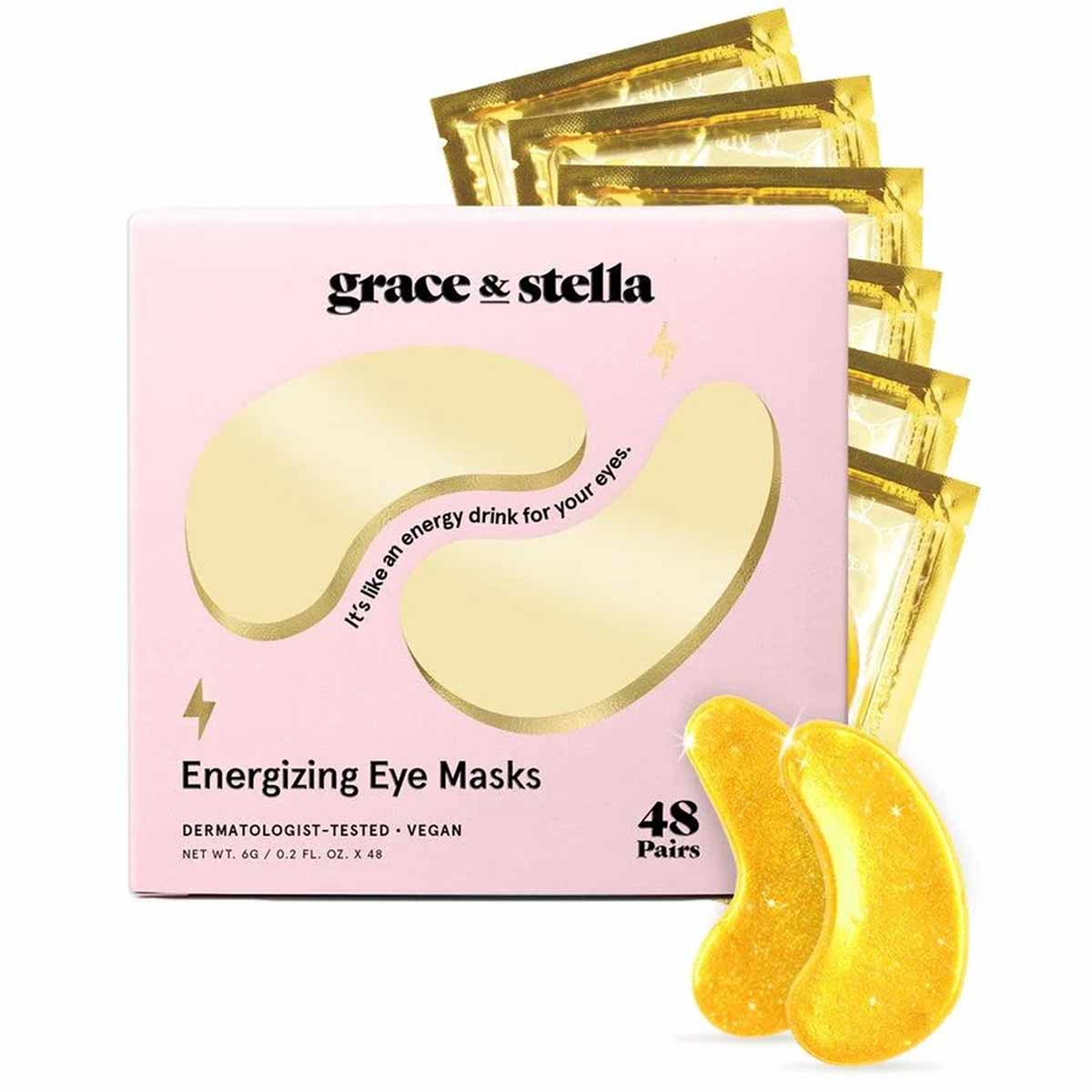 Grace & Stella pink box of energizing eye masks with gold foil packets and yellow gel eye mask samples displayed.
