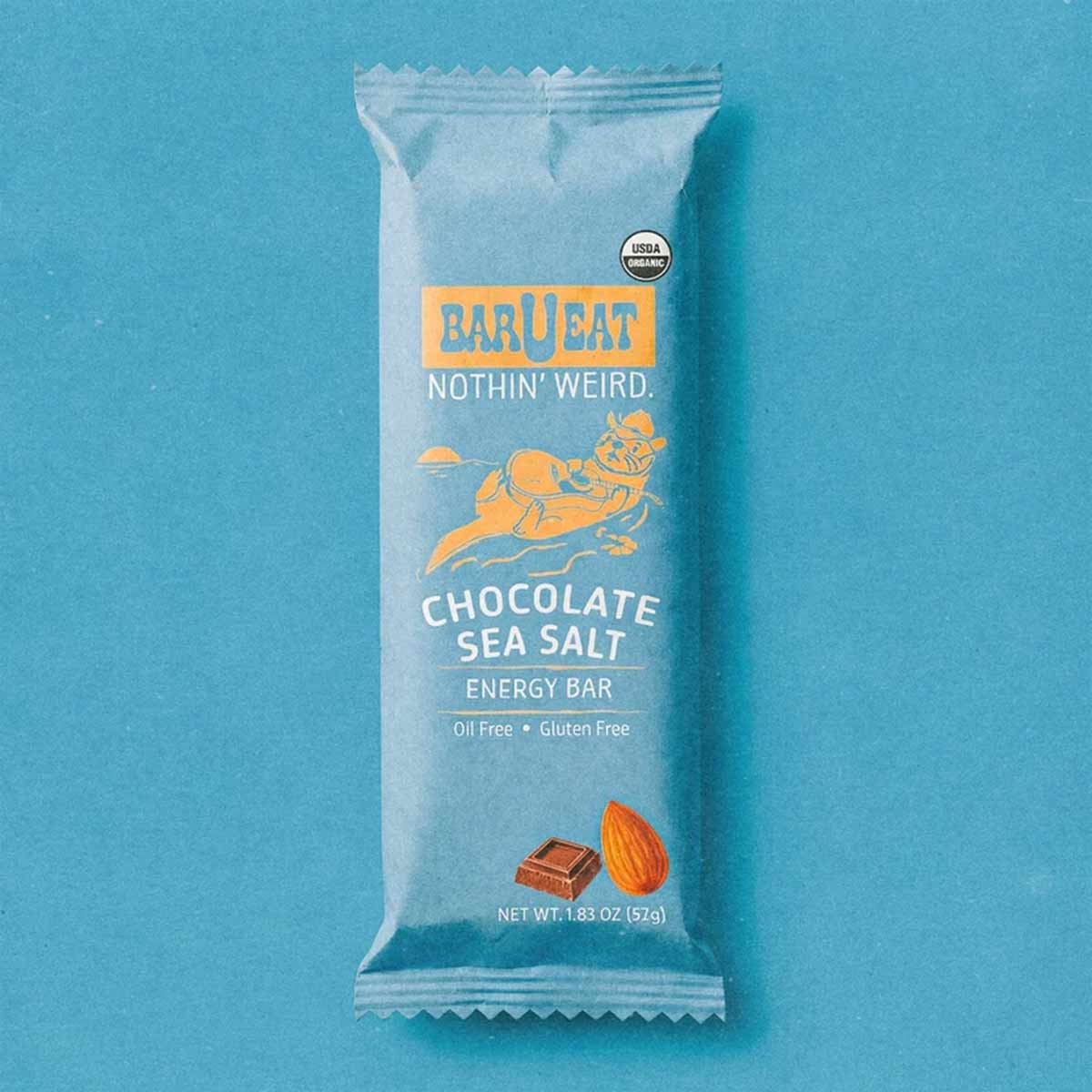 BAR U EAT chocolate sea salt energy bar in white wrapper with blue label and USDA organic seal on turquoise background.