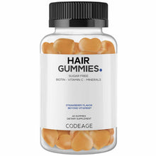 Clear glass bottle with black ridged cap containing 60 peach-colored hair gummies labeled "Hair Gummies" by Codeage.