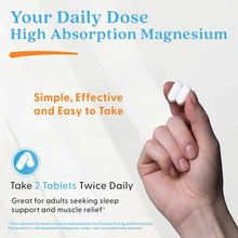 Hand holding two white magnesium supplement tablets against light background with product text.