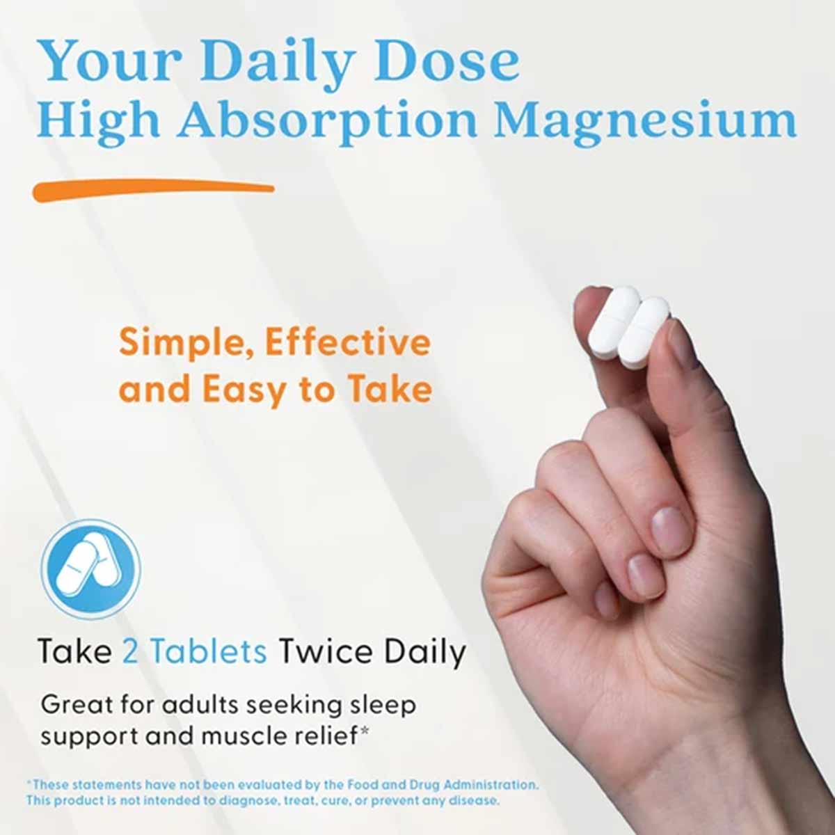 Hand holding two white magnesium supplement tablets against light background with product text.