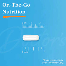 White oval zinc supplement capsule shown next to centimeter and inch rulers on blue background.
