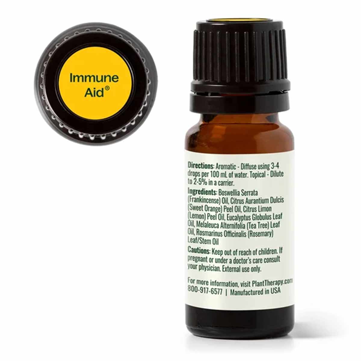 An amber glass dropper bottle with a black cap shows its back label of directions, ingredients, and cautions beside a yellow "Immune Aid" cap top.