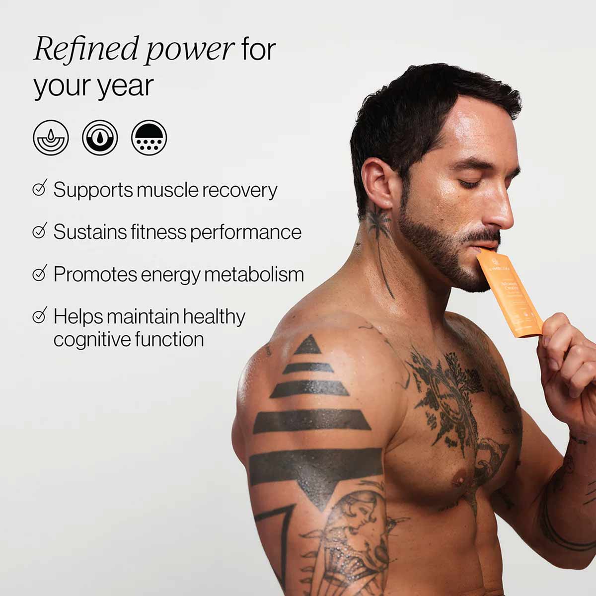 Man with tattoos holding tan-colored supplement packet near mouth, with product benefits listed on left side.