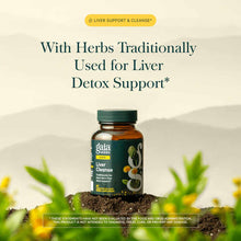 Gaia Herbs Liver Cleanse supplement bottle with green cap on soil surrounded by green plants and yellow flowers.