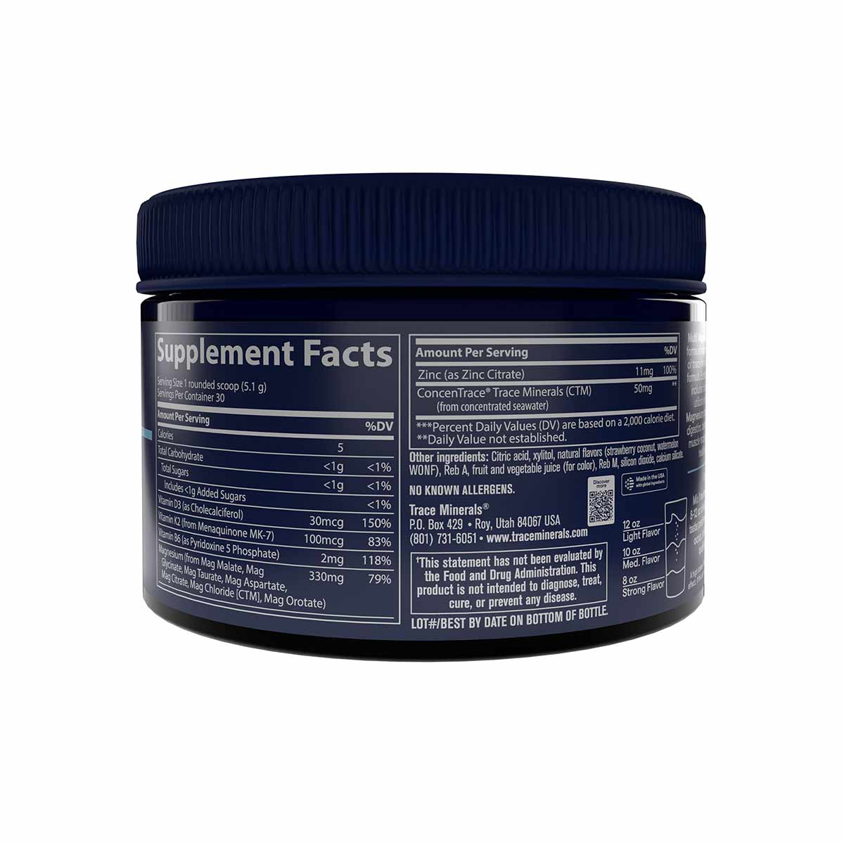 Dark glass jar with navy blue ridged lid containing magnesium powder with supplement facts label visible.