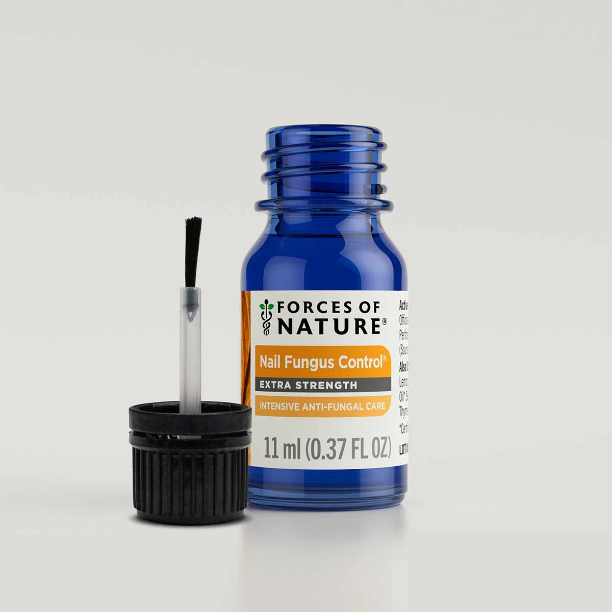Blue glass bottle of Forces Of Nature Nail Fungus Control Extra Strength 11 ml with brush applicator and black cap.