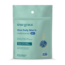Green pouch of True Grace One Daily Men's 40+ multivitamin with 90 vegan tablets and Non-GMO Verified seal.