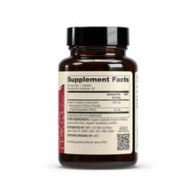 Dark amber glass bottle with black cap containing organic cranberry supplement capsules and PACs.