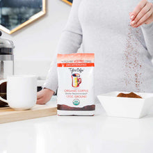 Tyler's organic decaf ground coffee 12 oz bag with person pouring grounds into white bowl.