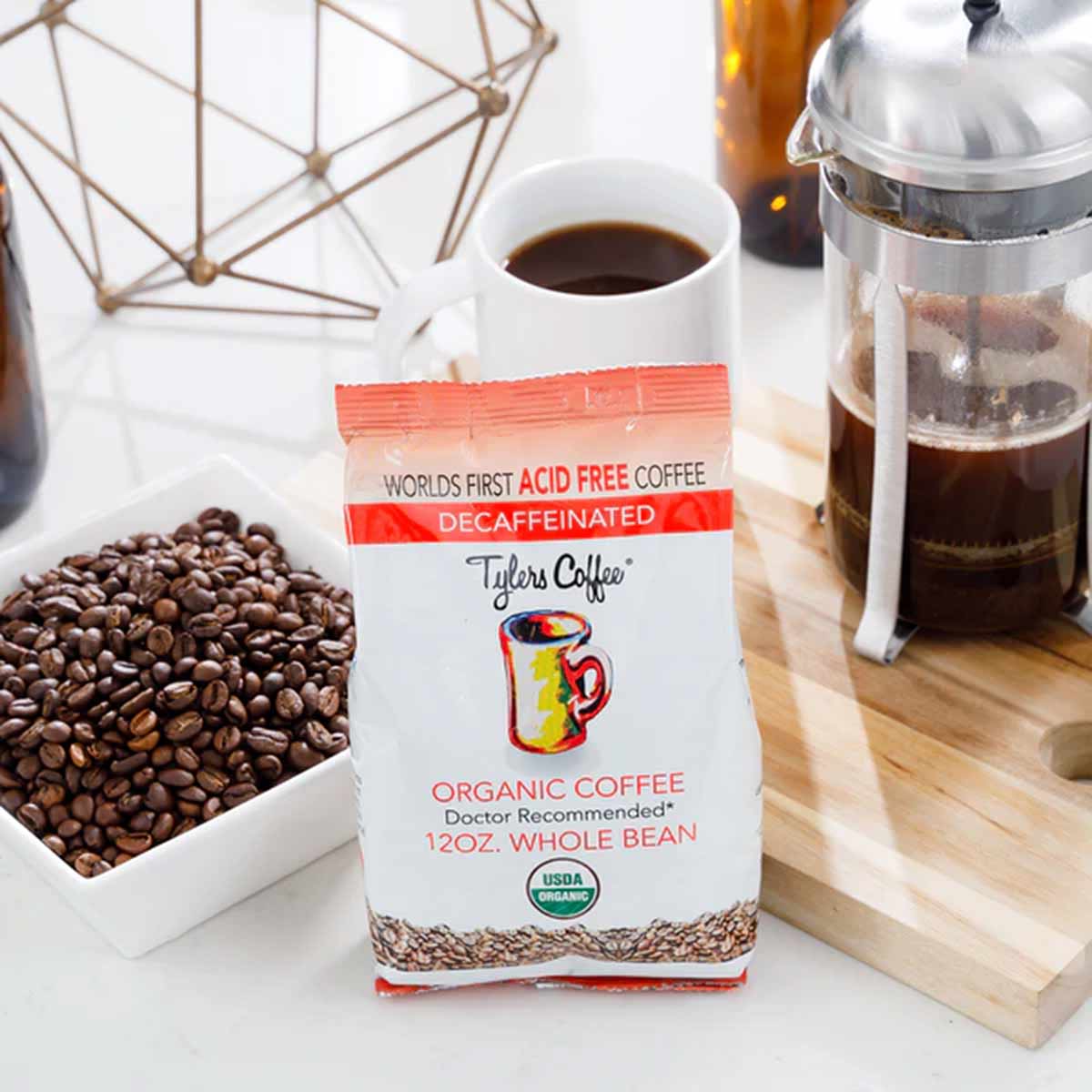 Tyler's Coffee 12 oz organic decaf whole bean coffee package displayed with whole beans in bowl and brewed coffee.