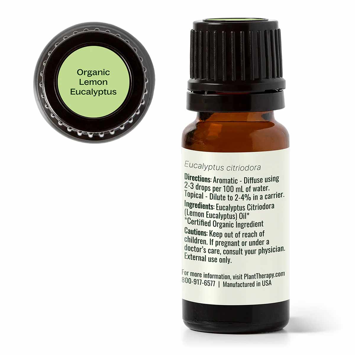 Small amber glass bottle with black cap containing lemon eucalyptus essential oil, with green label lid shown separately.