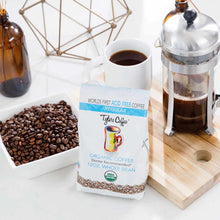 Tylers Coffee 12 oz organic whole bean coffee package displayed with roasted beans, brewed cup, and French press.