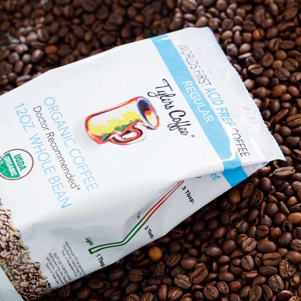 Tyler's Coffee 12 oz bag of organic regular whole bean coffee on bed of coffee beans.