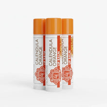 Three orange lip balm tubes with white labels and orange caps labeled "Calendula Orange Lip Balm" by Four Elements.